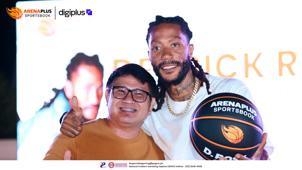 Derrick Rose poses with a fan while holding an ArenaPlus Sportsbook basketball at Champion's Circle Appreciation Dinner basketball event.
