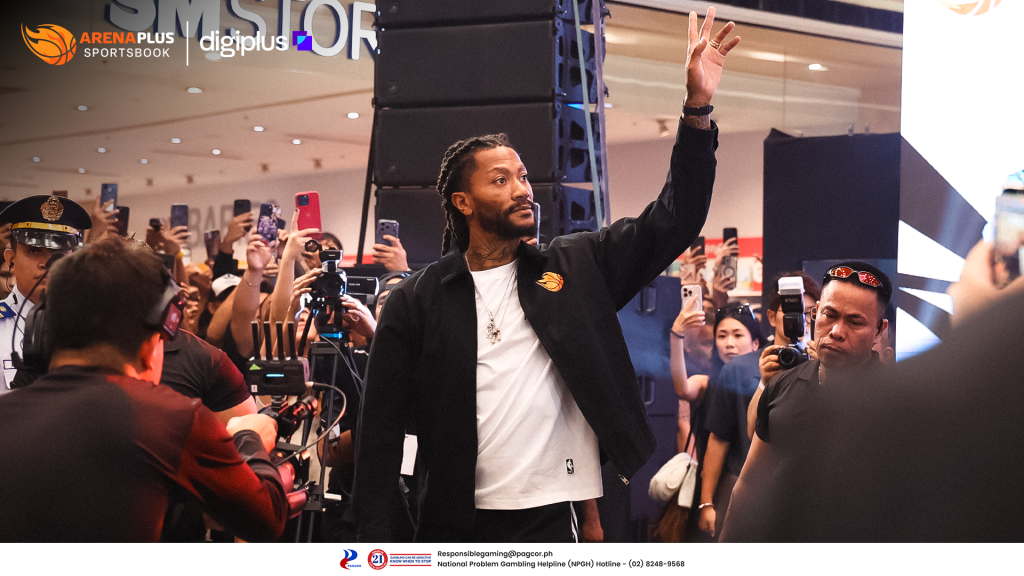 Derrick Rose waving to a crowd at an ArenaPlus event in Cebu, as fans and photographers capture the moment.